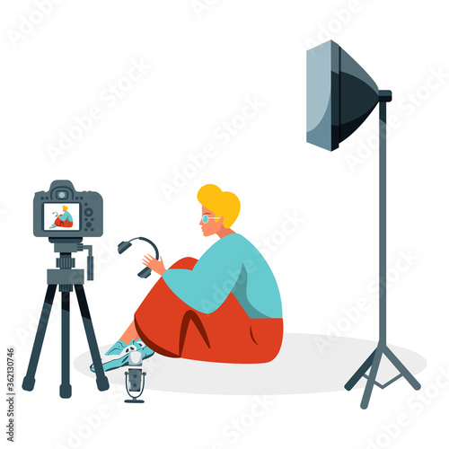 Video blogger recording video with camera and light. Vlog concept.
Cute vector illustration in flat style
