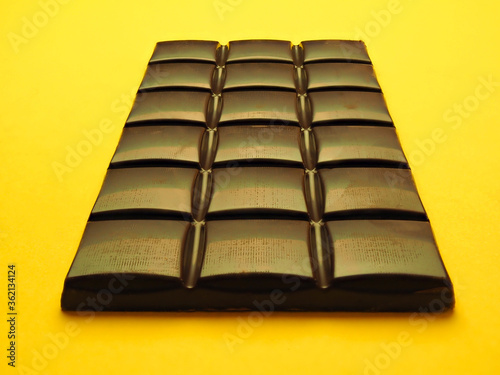 Chocolate bar on a yellow background photo