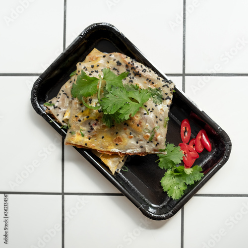 Top View of Fried Chinese Pancake or Fried Steamed Dumpling Made of Garlic Chives, Rice Flour and Tapioca Flour with chili on background. Traditional Food of China. photo