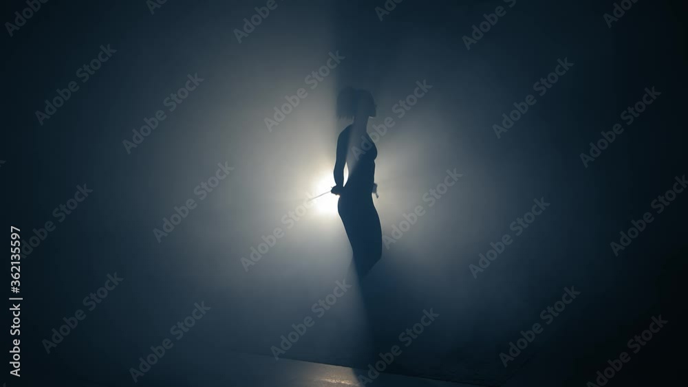 Rope jumping training Woman silhouette.Backlighted woman silhouette jumping rope alone. Fitness training woman silhouette. Agility, focusing, challenge concepts. Rope jumping training Woman silhouette.Backlighted woman silhouette jumping rope alone. Fitness training woman silhouette. Agility, focusing, challenge concepts.