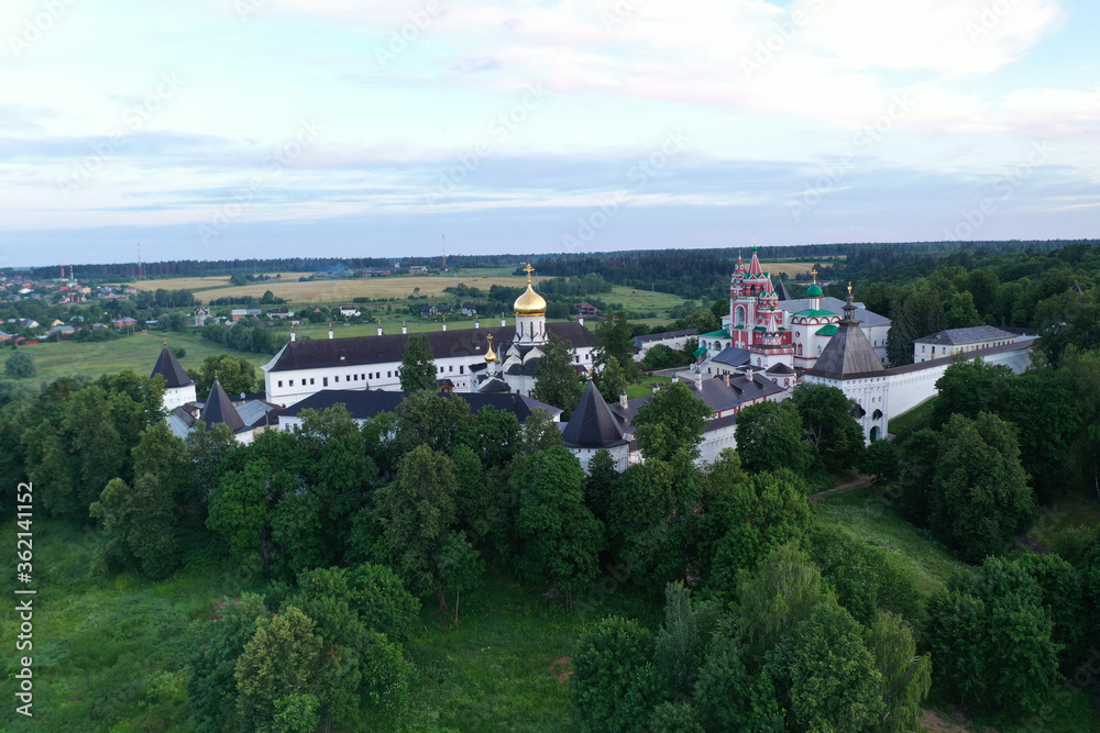ancient white stone fortress at dawn taken from a drone