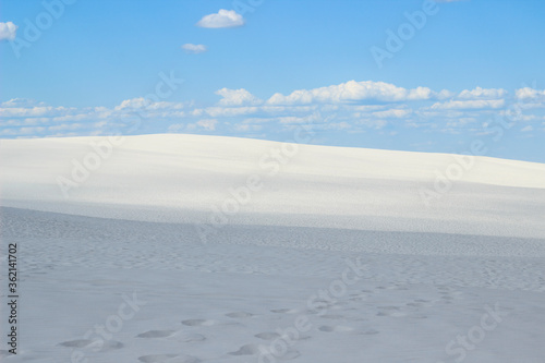 desert of white sand under an open sky with clouds © Nikolay
