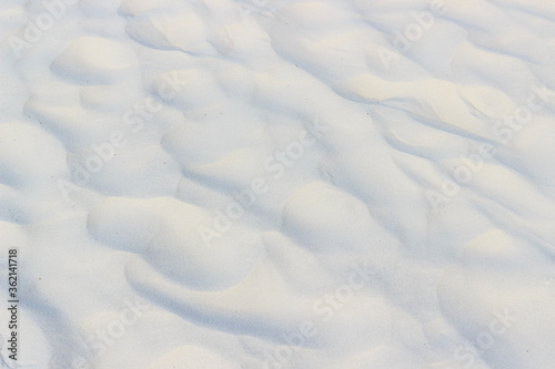 Wavy texture of white sand, background