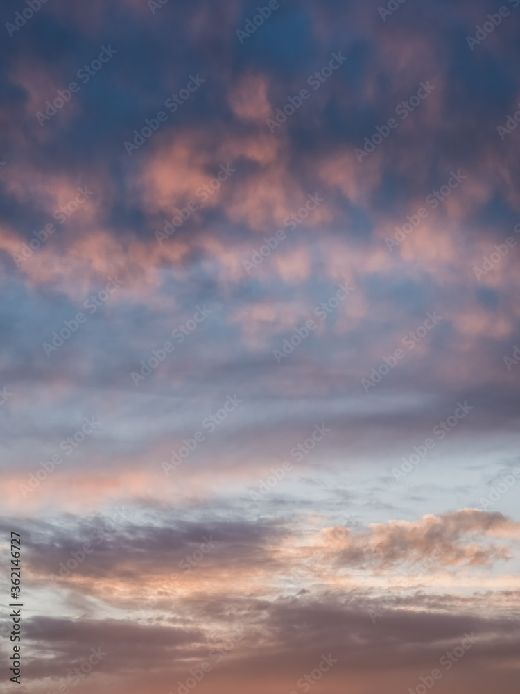 Light evening сumulus clouds in the sky. Colorful cloudy sky at sunset. Sky texture, abstract nature background Light evening сumulus clouds in the sky. Colorful cloudy sky at sunset. Sky texture, abstract nature background