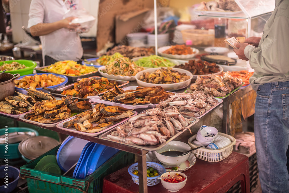 fruits, flowers and fish for sale at a market