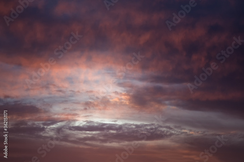 Formation of a cyclone in the sky. Colorful cloudy sky at sunset. Sky texture, abstract nature background
