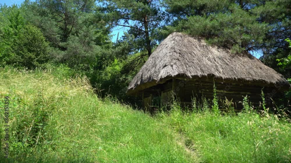 Old, medieval, traditional Ukrainian rural house with wicker hedge and garden with flowers. Old, medieval, traditional Ukrainian rural house with wicker hedge and garden with flowers.