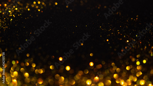 Abstract holiday background, gold Stardust on black. © Ulia Koltyrina
