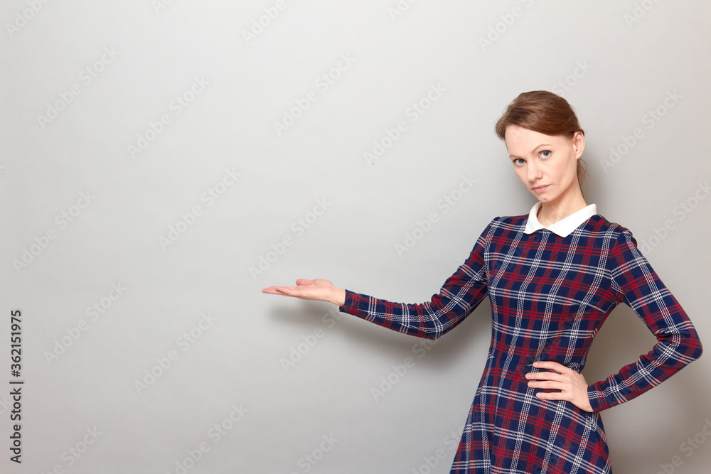 Portrait of serious concentrated girl pointing with hand at copy space Portrait of serious concentrated girl pointing with hand at copy space