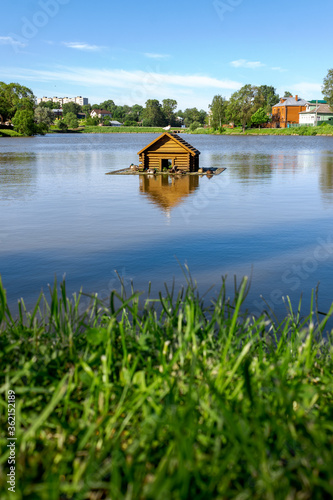 House for birds on the water in the middle of the lake. Seagulls and wild ducks.