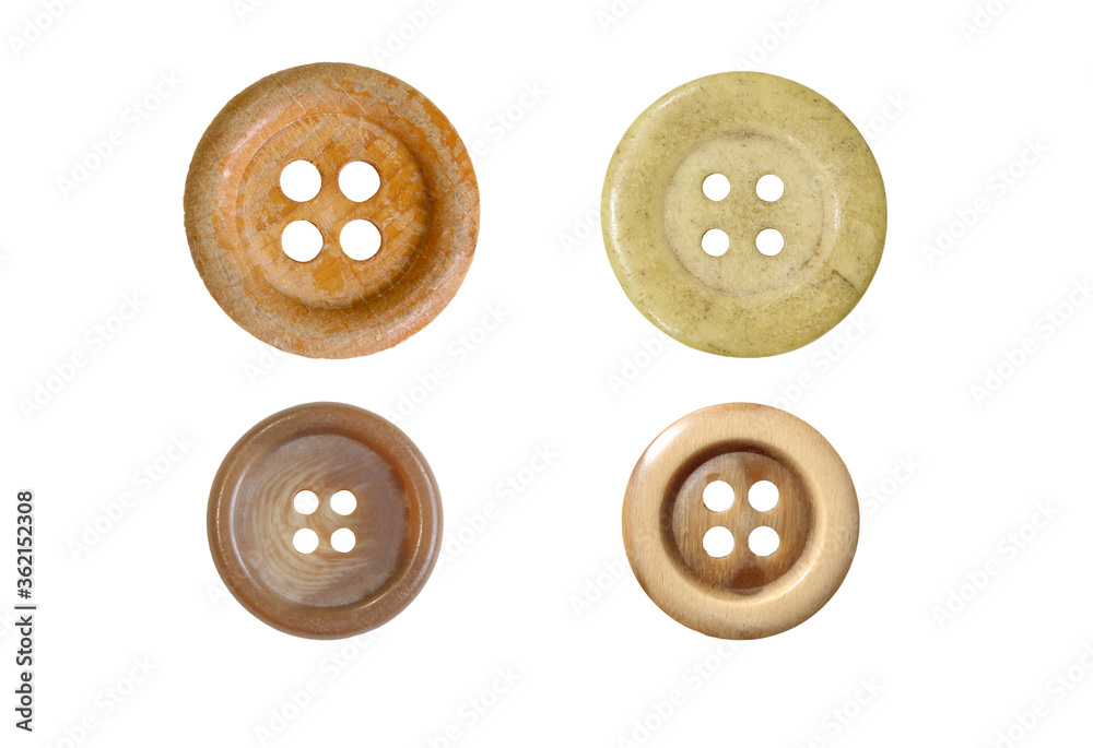 Four different sewing buttons for clothes isolated on white background.