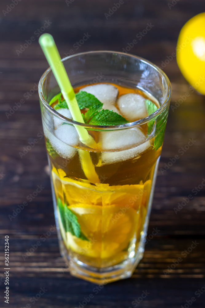 Cold tea with lemon and mint. A summer drink. Healthy eating. Vegetarian food. Diet. Cold tea with lemon and mint. A summer drink. Healthy eating. Vegetarian food. Diet.