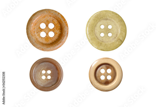 Four different sewing buttons for clothes isolated on white background.
