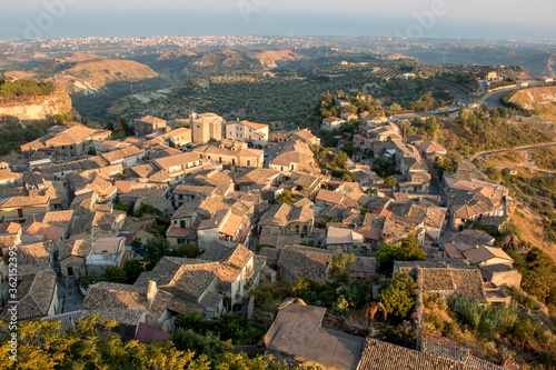 aerial view of Gerace, Calabria (Italy) at the sunset on a hill. A south italian village. it is possible see the stone houses and the wood around them.  © Giampaolo