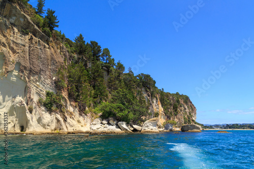 Shakespeare Cliff, an outcrop of white volcanic rock on the Coromandel Peninsula, New Zealand, seen from the ocean