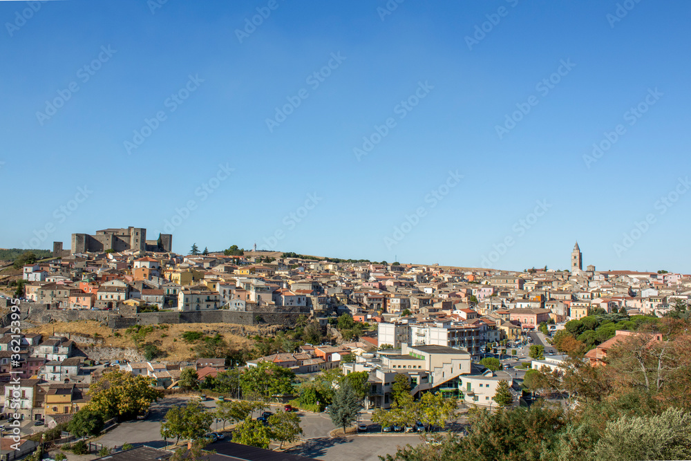 Rural panoramic view of Melfi. Skyline of Melfi ( basilicata ) during a summer day. It is possible see the wheat fields and a medieval castle in background with a sunny clear sky.