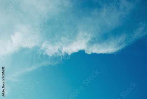Blue tone of evening cloud and sky before sunset. Peaceful sky in calm atmosphere. A fluctuation weather make a dreamy and imaginative cloudscape. Wide blue sky background.