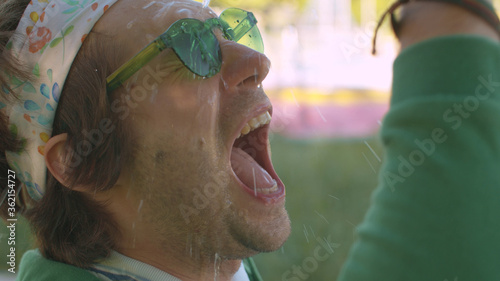 Funny freak sprays water on his face