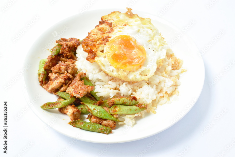 spicy fried pork with slice yard long bean in curry on rice topping egg spicy fried pork with slice yard long bean in curry on rice topping egg