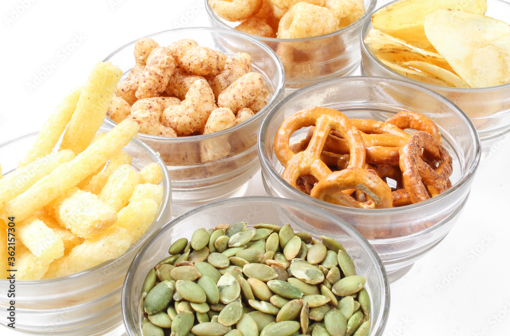 Assorted salty snacks and crisps. Closeup of junk food for party Assorted salty snacks and crisps. Closeup of junk food for party