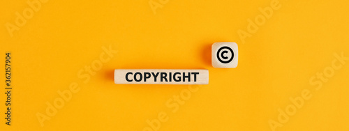 The word copyright and copyright symbol on wooden blocks. Concept of patenting. or copyright protection. photo