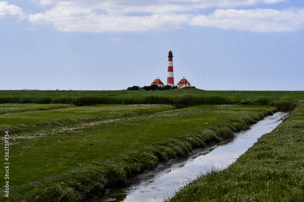The famous lighthouse in Westerhever with a great sky and clouds The famous lighthouse in Westerhever with a great sky and clouds