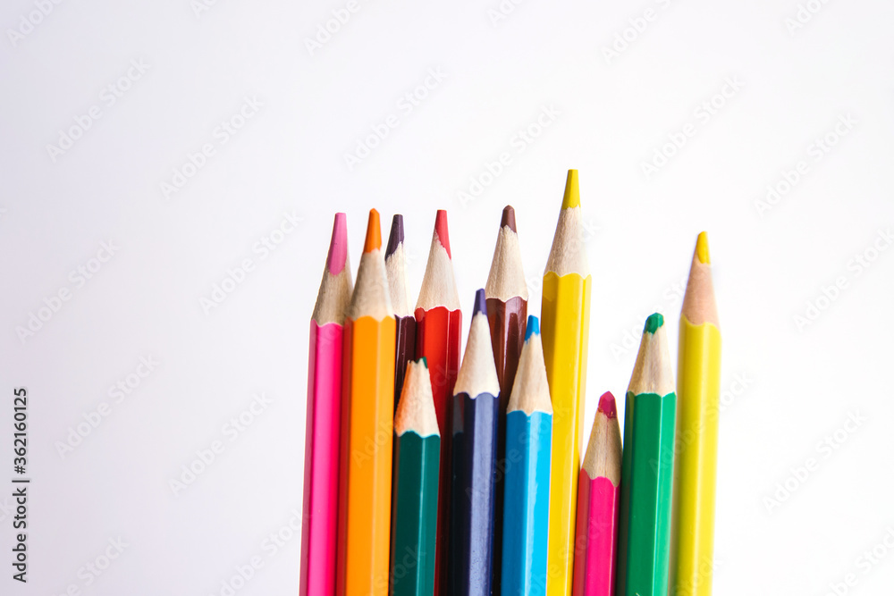 Colored pencils on a white background. Variety of colors. School supplies. Colored pencils on a white background. Variety of colors. School supplies.
