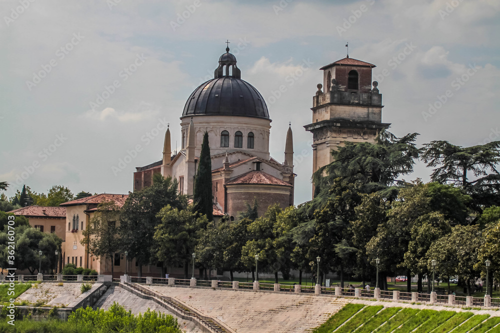 View of catholic church (Parrocchia di San Giorgio in Braida) on the riverbank of Adige river in Verona.