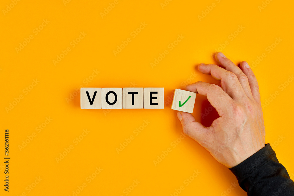 concept-of-voting-yes-or-positive-vote-male-hand-placing-wooden-cube