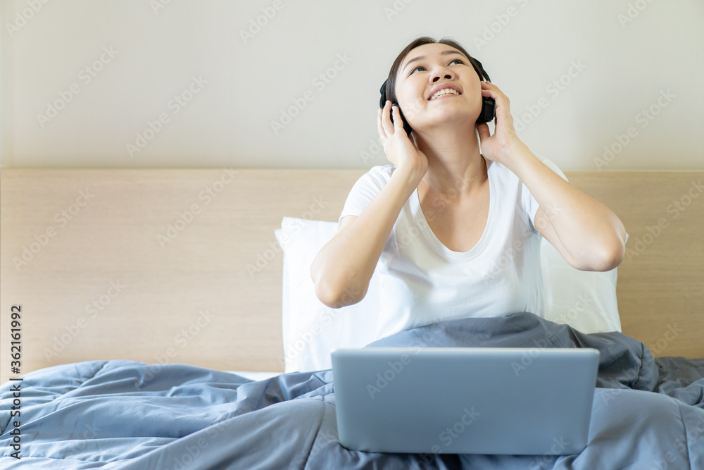 Asian young woman's portrait in working at home concept. Happy Asian woman showing OK sign during using video conference with her friend during stay at home. Joyful woman browsing the internet. Asian young woman's portrait in working at home concept. Happy Asian woman showing OK sign during using video conference with her friend during stay at home. Joyful woman browsing the internet.