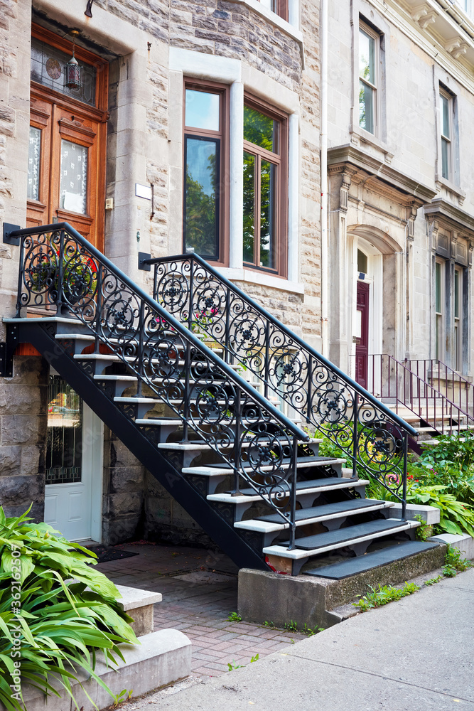 Stone facades and the entrance stairs of row houses in Montreal, Canada.