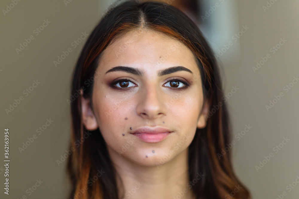 Beautiful model in make up process. Portrait of young pretty woman with beutiful makeup in beauty studio salon. Evening make up. Beautiful model in make up process. Portrait of young pretty woman with beutiful makeup in beauty studio salon. Evening make up.