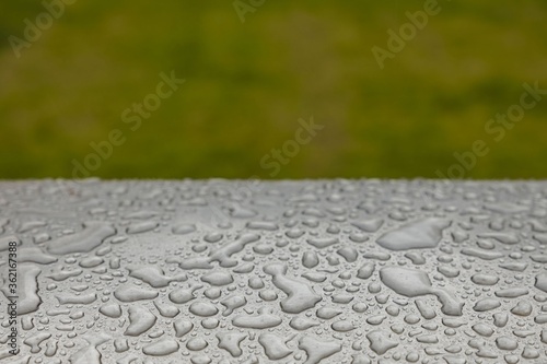 Beautiful background texture of rain water drops on grey black metal surface. Beautiful backgrounds.