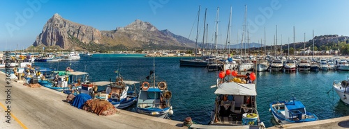 A panorama view across the harbour of San Vito lo Capo, Sicily with impressive mountain backdrop in summer