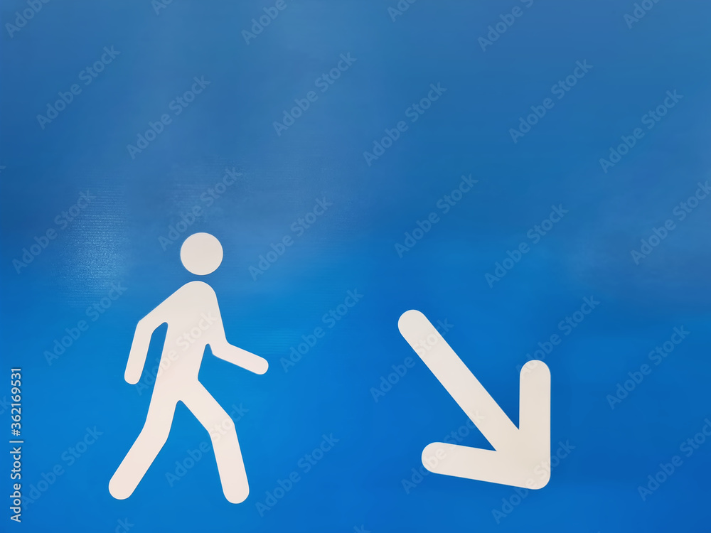 White Directional Symbol with Walking Man and Arrow Pointing to Down to the Right White Directional Symbol with Walking Man and Arrow Pointing to Down to the Right