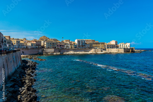 A view along the shoreline towards Fort Vigliena on Ortygia island in Syracuse, Sicily in summer