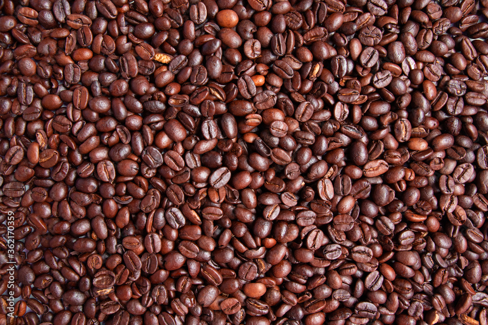Brown roasted coffee beans background. Arabic fragrant fried coffee beans close up. Brown roasted coffee beans background. Arabic fragrant fried coffee beans close up.