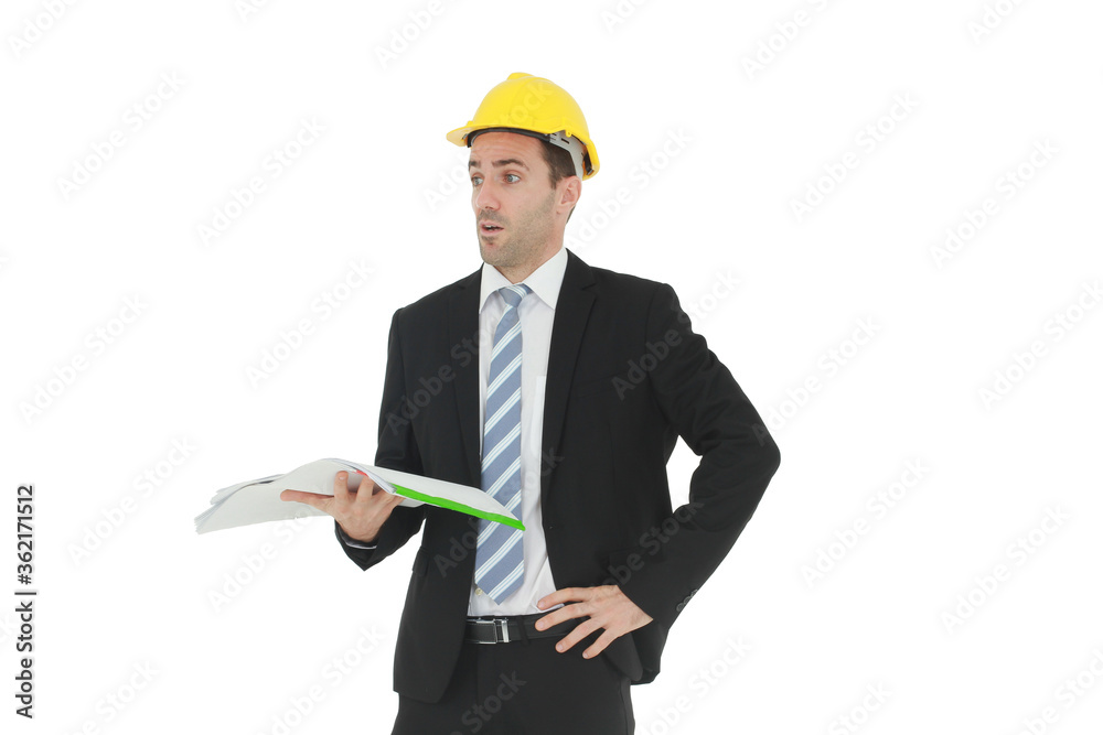 Handsome and smart engineer or architecture in black suit Wearing a yellow safety engineer hat with hand holding construction drawing papers and serious in work isolated on yellow background. Handsome and smart engineer or architecture in black suit Wearing a yellow safety engineer hat with hand holding construction drawing papers and serious in work isolated on yellow background.