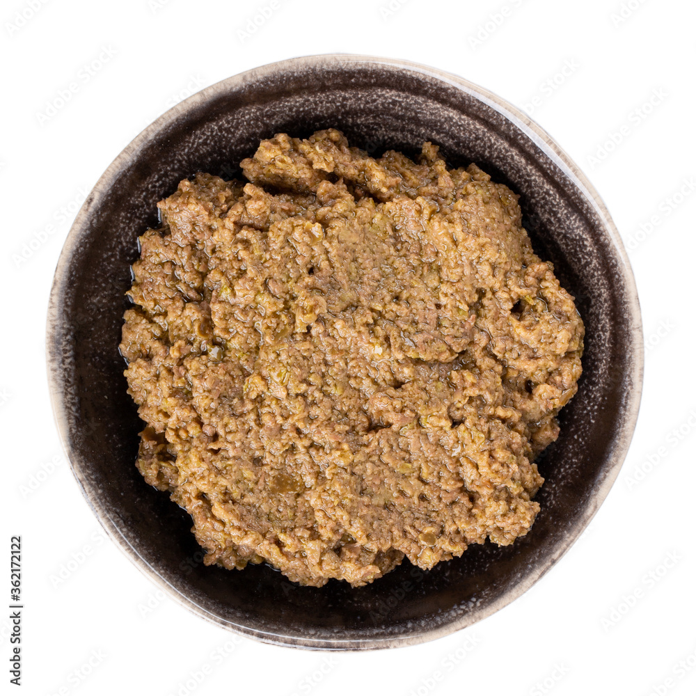 Tapenade - olive paste made from green olives. Spreadable green olive cream in bowl isolated on white. Tapenade - olive paste made from green olives. Spreadable green olive cream in bowl isolated on white.