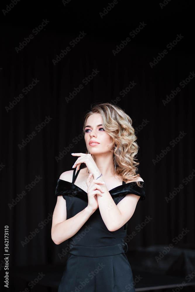 Beautiful blonde, young girl. Portrait of a young girl in a restaurant. Young girl in a restaurant on a black background. Portrait of a girl in a black dress. Young girl. Beautiful blonde, young girl. Portrait of a young girl in a restaurant. Young girl in a restaurant on a black background. Portrait of a girl in a black dress. Young girl.