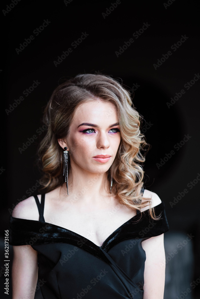 Beautiful blonde, young girl. Portrait of a young girl in a restaurant. Young girl in a restaurant on a black background. Portrait of a girl in a black dress. Young girl. Beautiful blonde, young girl. Portrait of a young girl in a restaurant. Young girl in a restaurant on a black background. Portrait of a girl in a black dress. Young girl.