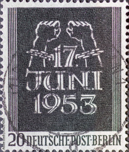 GERMANY, Berlin - CIRCA 1953: a postage stamp from Germany, Berlin showing bound hands break the chains and inscription June 17th. Memory of the June 17, 1953 uprising. color: black.
