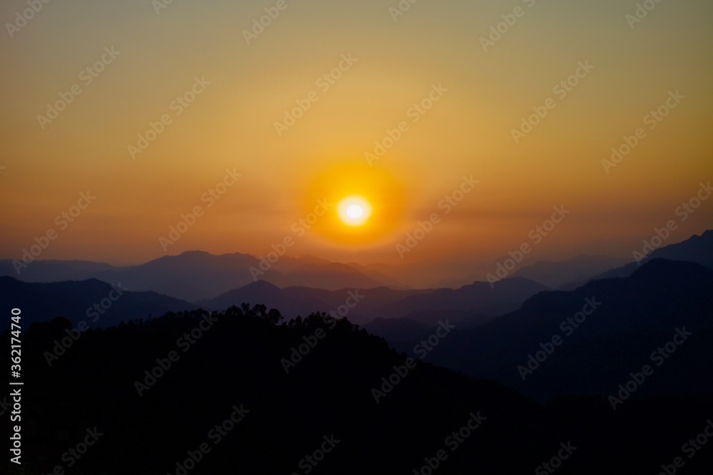 Majestic colorful sunrise in Nepal Himalayan mountains. Mountains ranges on Beautiful golden sunrise background. Panoramic Scenic sunrise view.  Mountains ranges and Bright colorful clear morning sky.