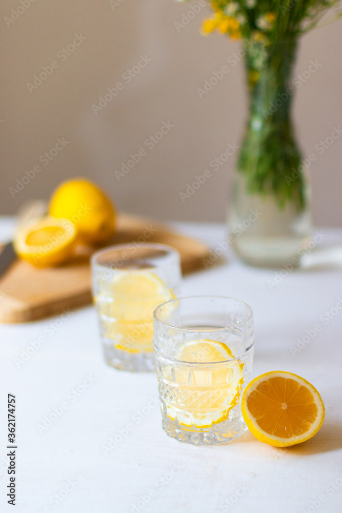 Top view of cold refreshing lemonade in glass on white background for summer party. Summer drinks with ice Top view of cold refreshing lemonade in glass on white background for summer party. Summer drinks with ice