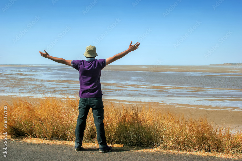 Winning, success , and life goals concept. Young man with arms in the air giving thumbs up. Winning, success , and life goals concept. Young man with arms in the air giving thumbs up.