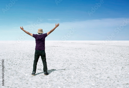 Happy man with hands up standing on Rann of Kutch, Gujarat, India