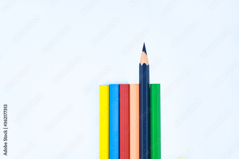 Six different colored wood pencil crayon while one facing different way Six different colored wood pencil crayon while one facing different way