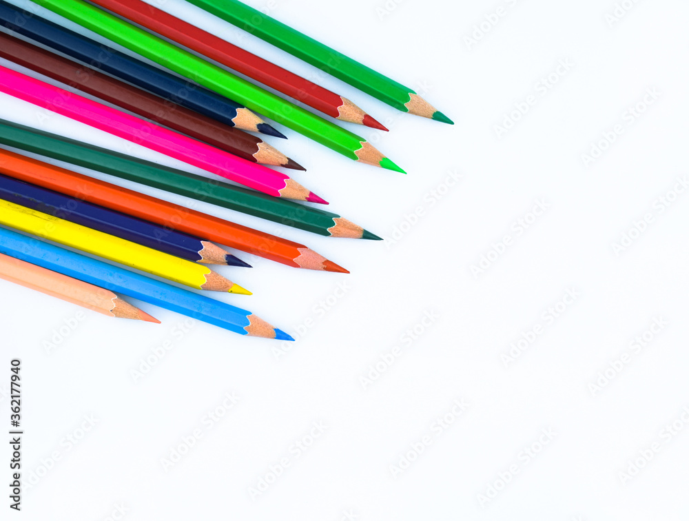 Close up picture of stack of different colored wood pencil crayon on a white background Close up picture of stack of different colored wood pencil crayon on a white background