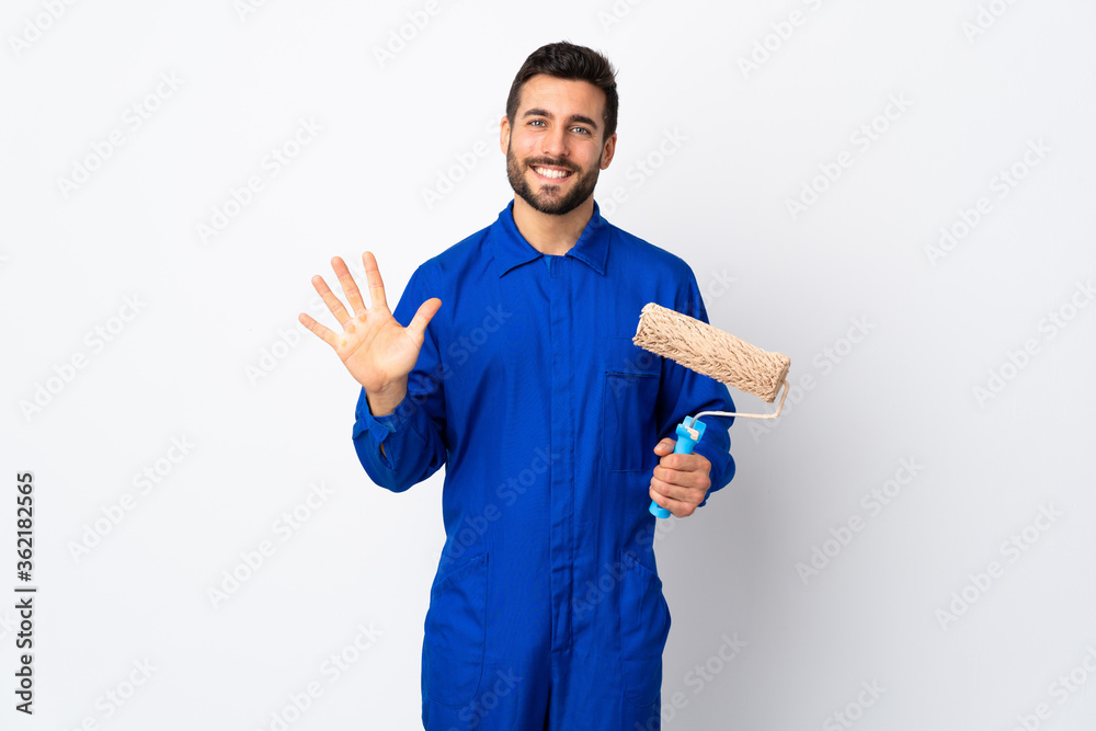 Painter man holding a paint roller isolated on white background counting five with fingers Painter man holding a paint roller isolated on white background counting five with fingers