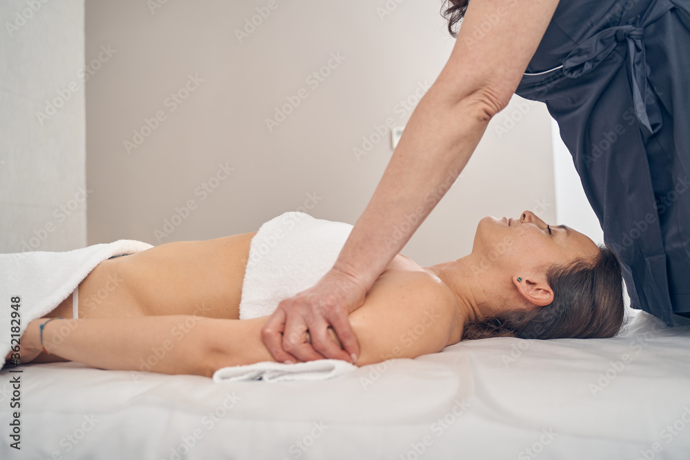 Fototapeta premium Finishing massage buy pushing the arms of client